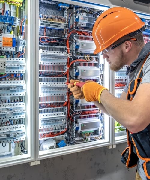 Electrician working on an electrical panel
